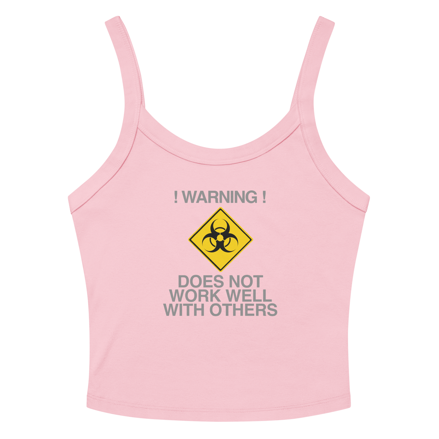 "!Warning! Does Not Work Well With Others" printed on a solid pink blend women's micro-rib tanktop laying on a flat surface amongst sunglasses and shorts