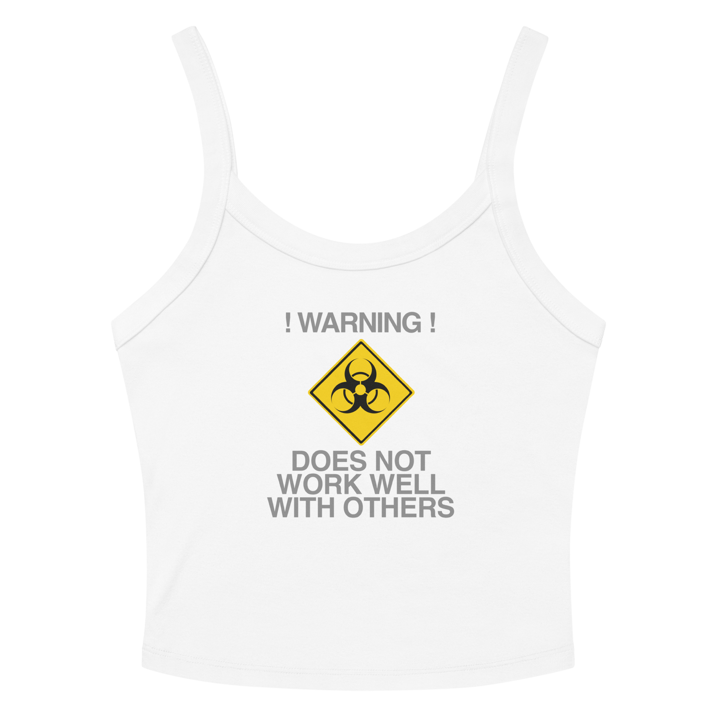 "!Warning! Does Not Work Well With Others" printed on a solid white blend women's micro-rib tanktop laying on a flat surface amongst sunglasses and shorts