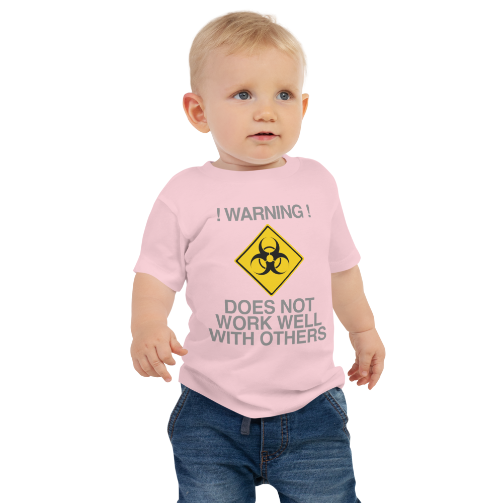 "!Warning! Does Not Work Well With Others" printed on a pink baby jersey short sleeve tee worn by a male