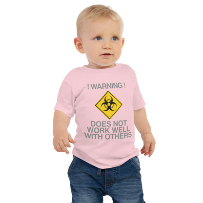 "!Warning! Does Not Work Well With Others" printed on a pink baby jersey short sleeve tee worn by a male