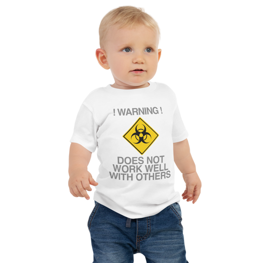 "!Warning! Does Not Work Well With Others" printed on a white baby jersey short sleeve tee worn by a male
