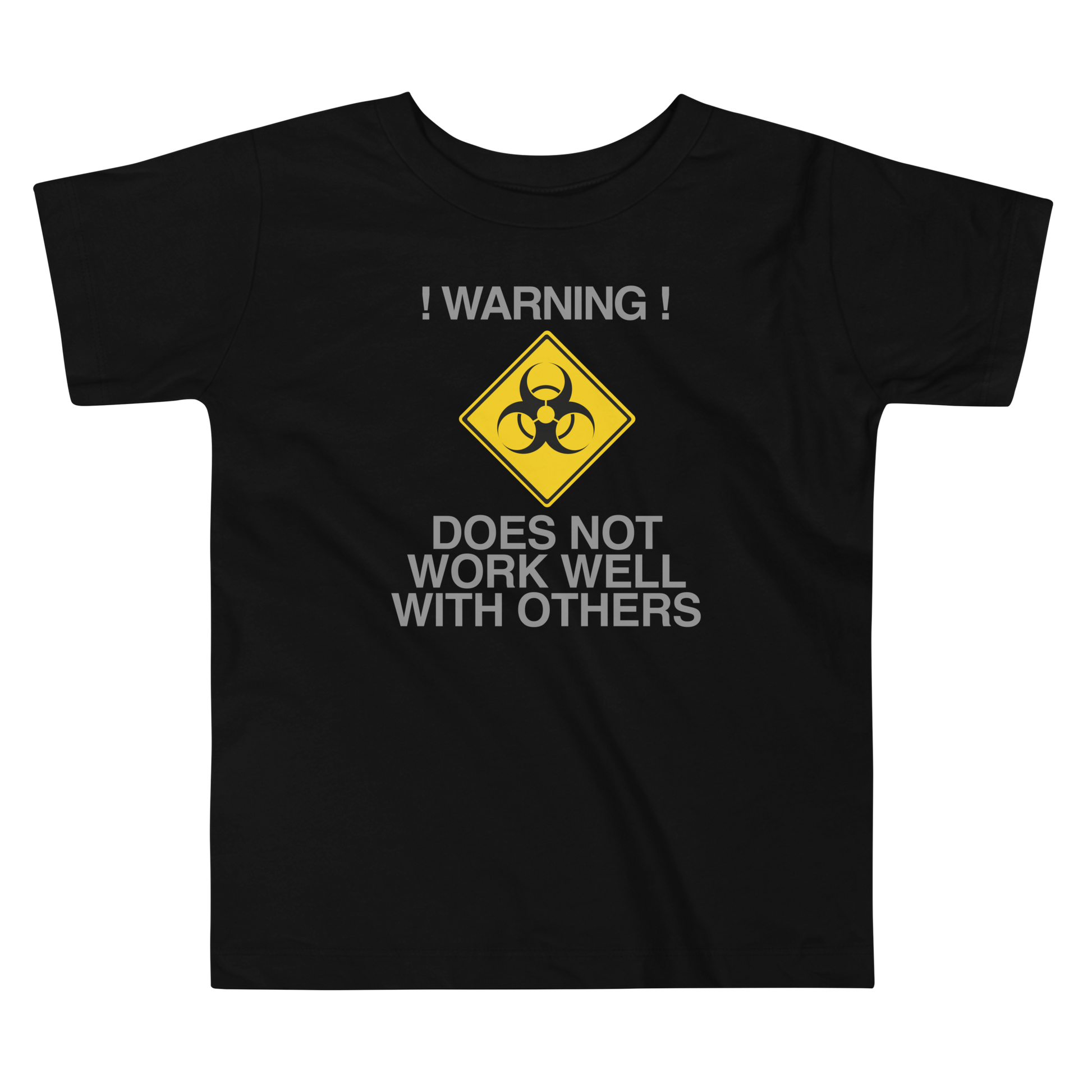 "!Warning! Does Not Work Well With Others" printed on a black toddler short sleeve tee laying on a flat surface