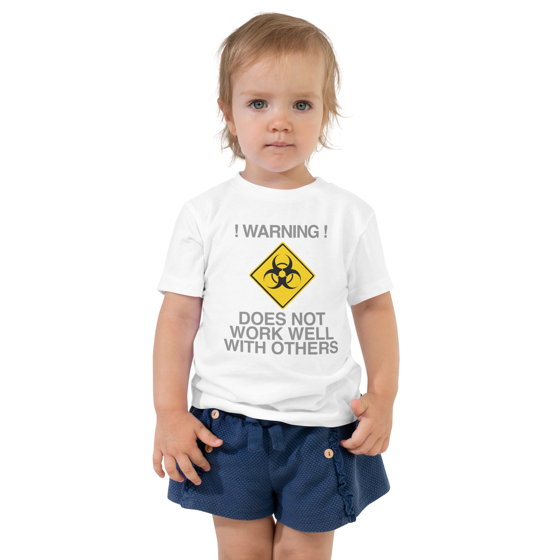 "!Warning! Does Not Work Well With Others" printed on a white toddler short sleeve tee worn by a female