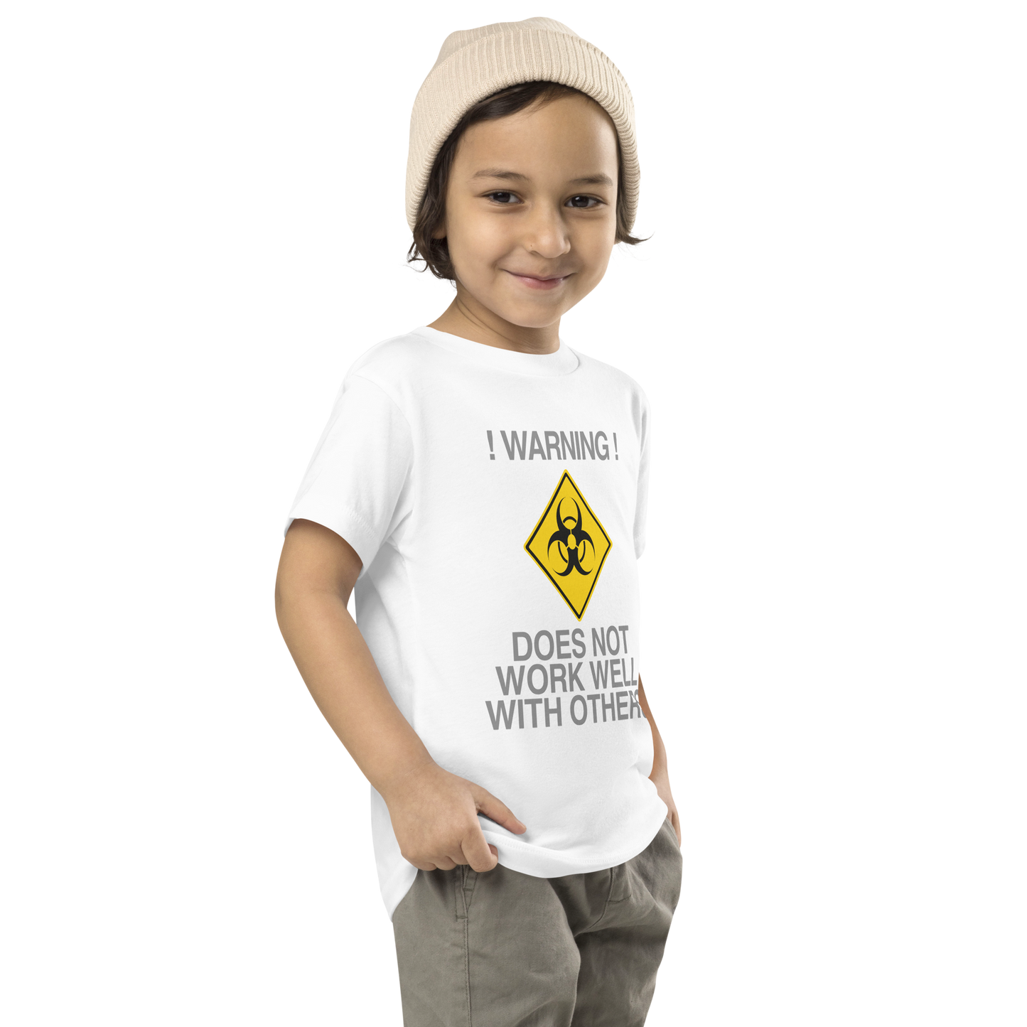 "!Warning! Does Not Work Well With Others" printed on a white toddler short sleeve tee worn by a male who is also wearing a knit cap