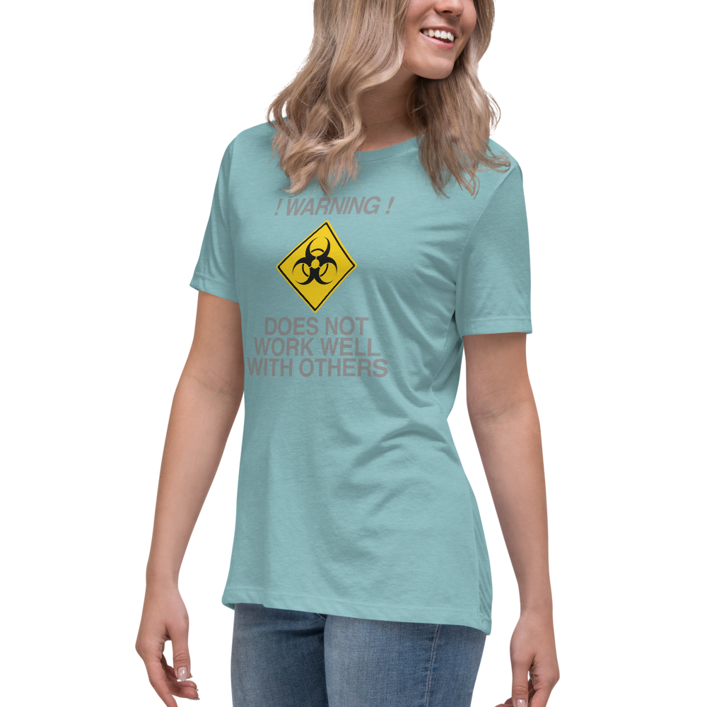"!Warning! Does Not Work Well With Others" printed on a heather blue lagoon women's relaxed t-shirt worn by a female