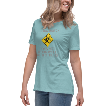 "!Warning! Does Not Work Well With Others" printed on a heather blue lagoon women's relaxed t-shirt worn by a female