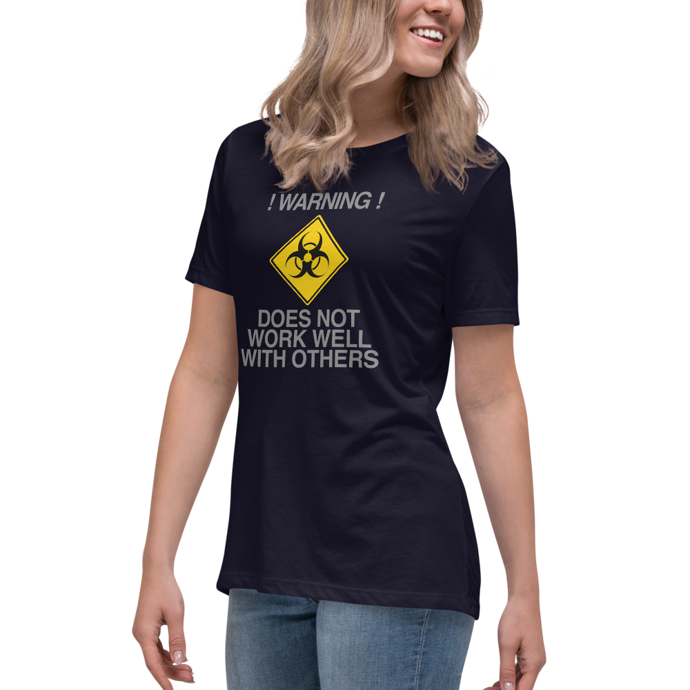"!Warning! Does Not Work Well With Others" printed on a navy women's relaxed t-shirt worn by a female