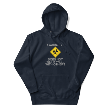 "!Warning! Does Not Work Well With Others" printed on a navy blazer unisex hoodie laying on a flat surface with the hood up