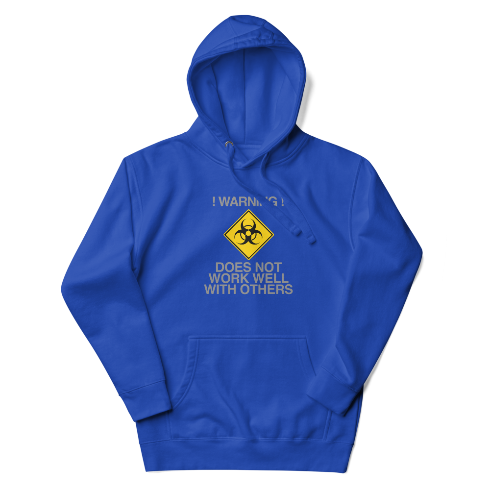 "!Warning! Does Not Work Well With Others" printed on a team royal unisex hoodie laying on a flat surface with the hood up