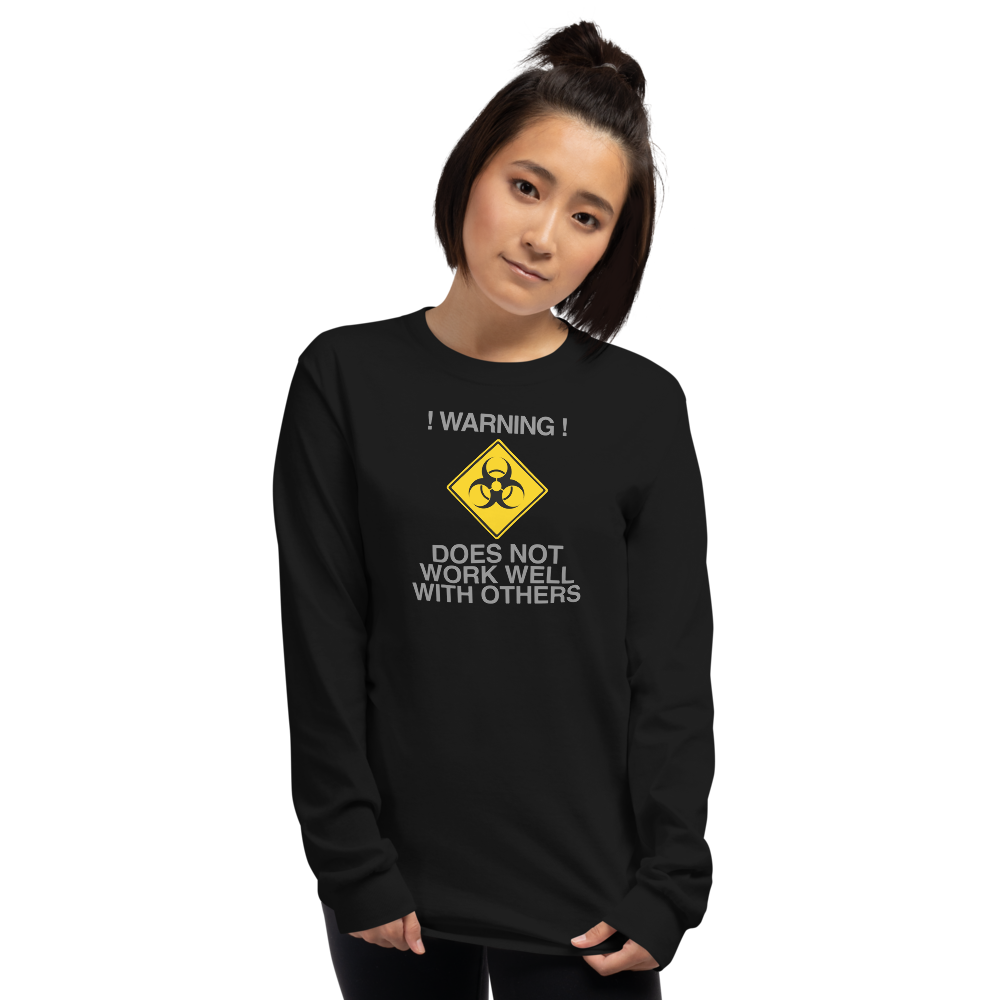 "!Warning! Does Not Work Well With Others" printed on a black men's long sleeve shirt worn by a female