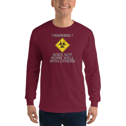 "!Warning! Does Not Work Well With Others" printed on a maroon men's long sleeve shirt worn by a male