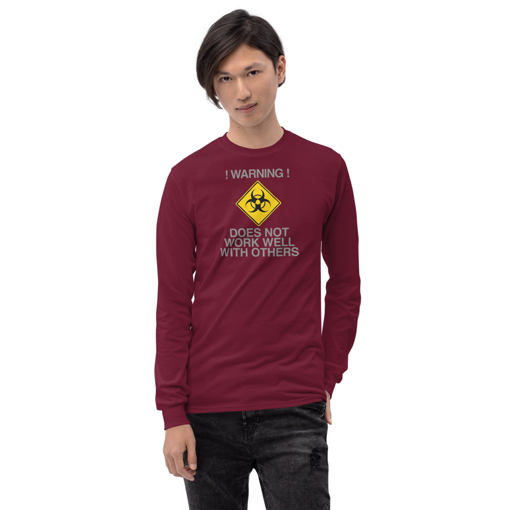 "!Warning! Does Not Work Well With Others" printed on a maroon men's long sleeve shirt worn by a male