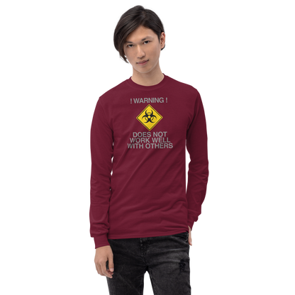"!Warning! Does Not Work Well With Others" printed on a maroon men's long sleeve shirt worn by a male