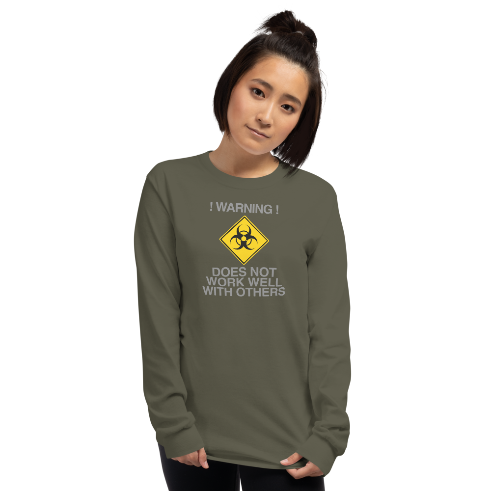 "!Warning! Does Not Work Well With Others" printed on a military green men's long sleeve shirt worn by a female