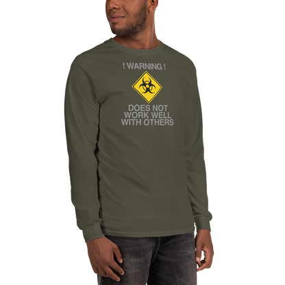 "!Warning! Does Not Work Well With Others" printed on a military green men's long sleeve shirt worn by a male