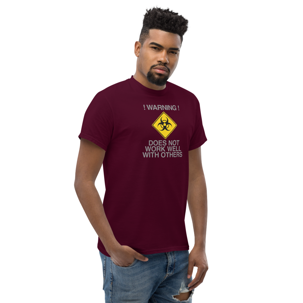 "!Warning! Does Not Work Well With Others" printed on a maroon unisex classic tee worn by a male
