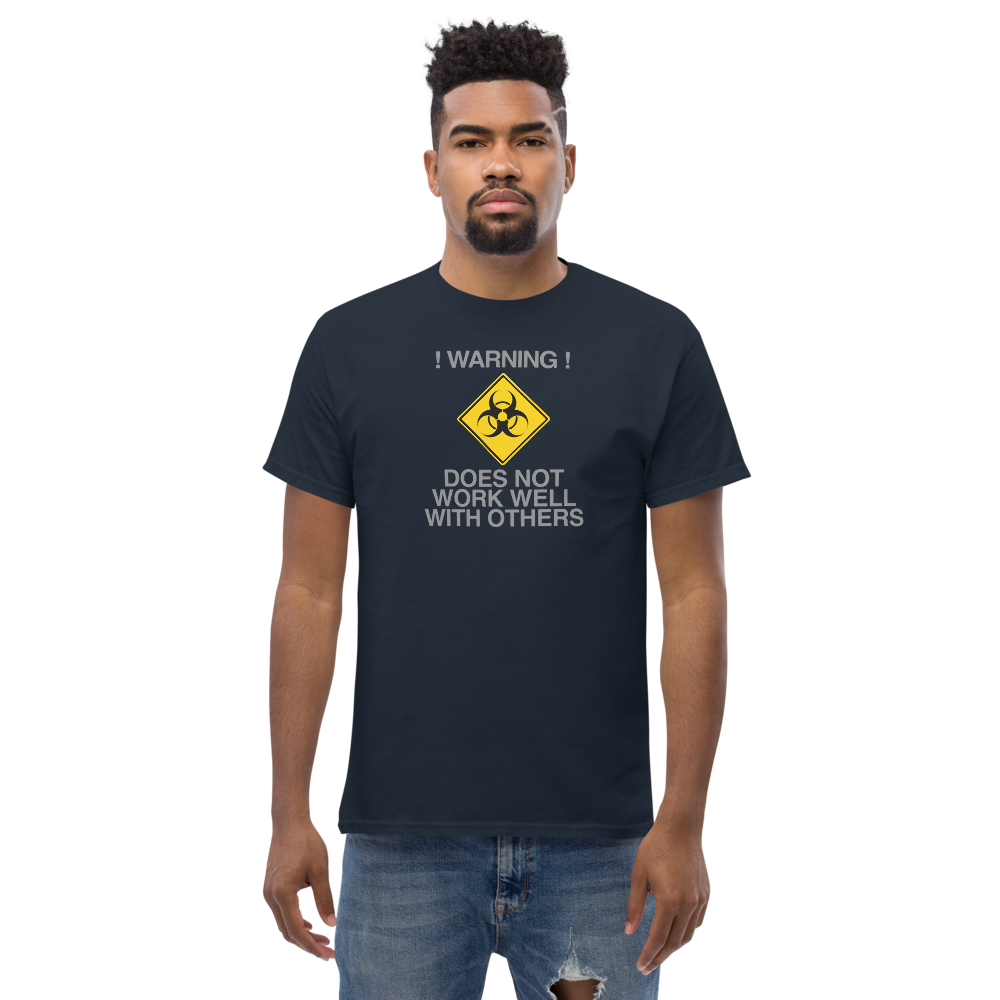 "!Warning! Does Not Work Well With Others" printed on a navy unisex classic tee worn by a male