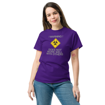 "!Warning! Does Not Work Well With Others" printed on a purple unisex classic tee worn by a female