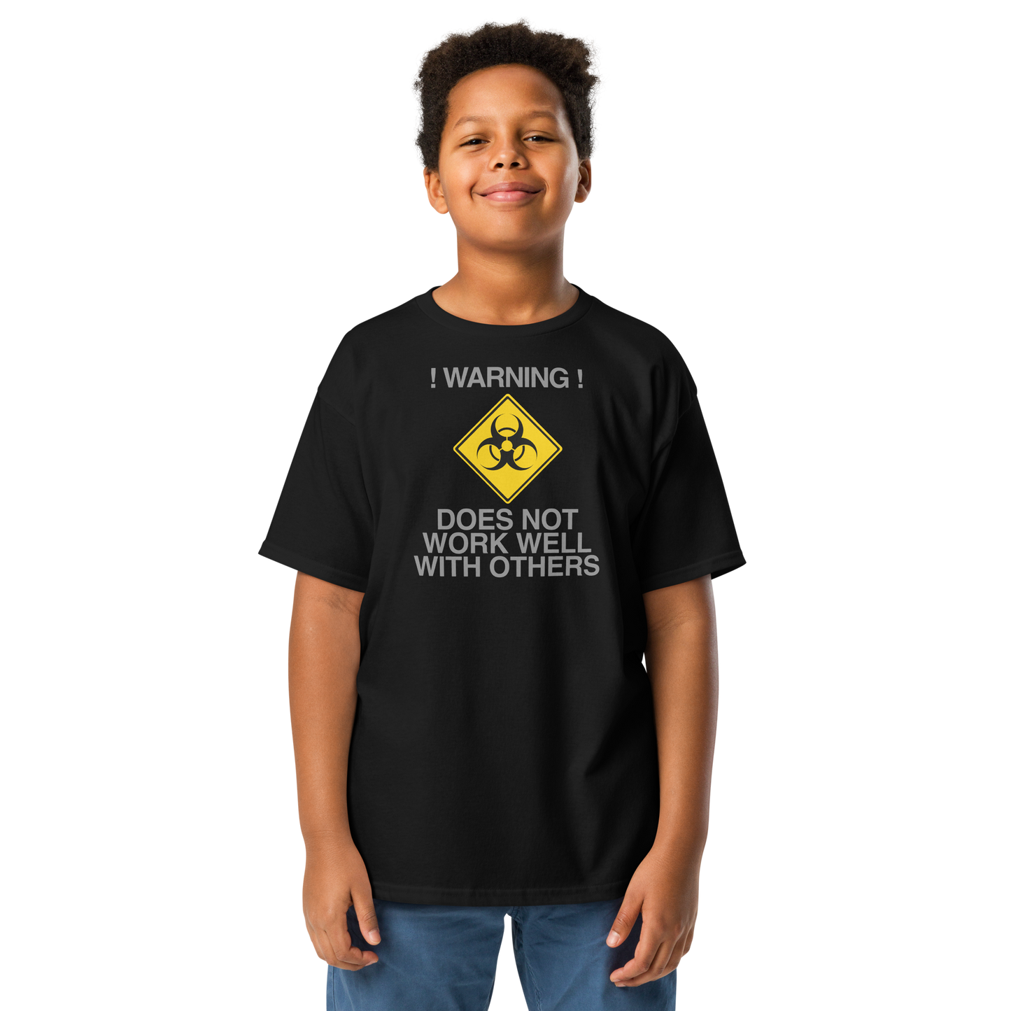 "!Warning! Does Not Work Well With Others" printed on a black youth classic tee worn by a male