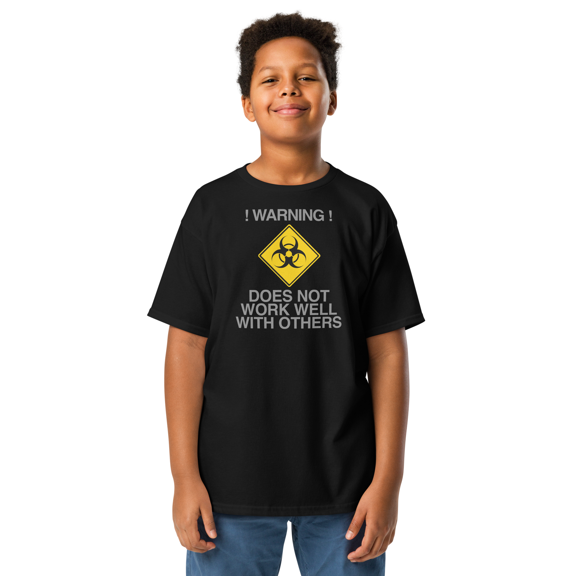 "!Warning! Does Not Work Well With Others" printed on a black youth classic tee worn by a male