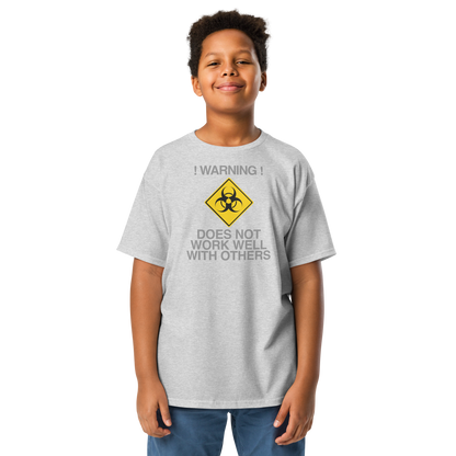 "!Warning! Does Not Work Well With Others" printed on a sport grey youth classic tee worn by a male