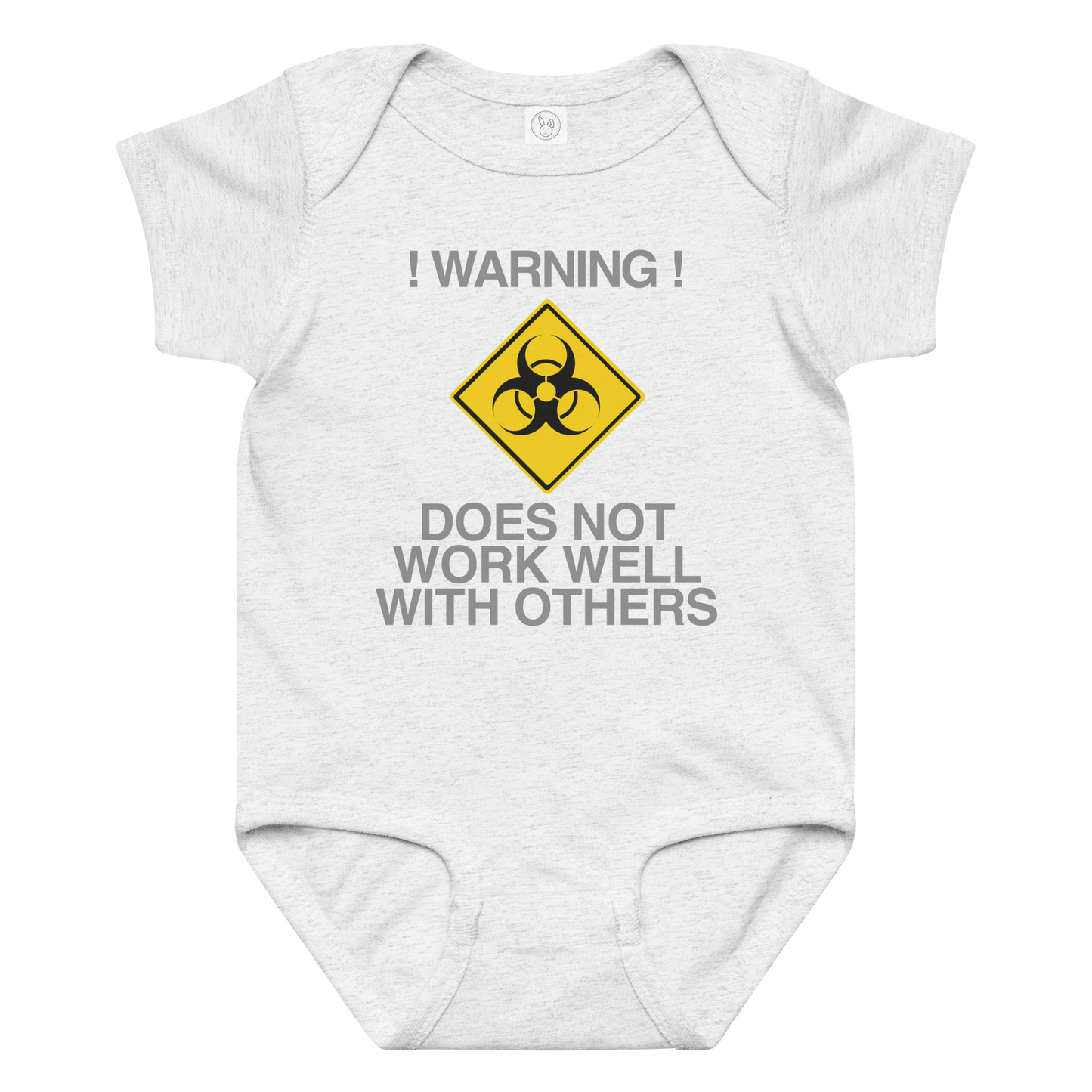 "!Warning! Does Not Work Well With Others" printed on a ash baby jersey bodysuit laying on a flat surface amongst other clothes