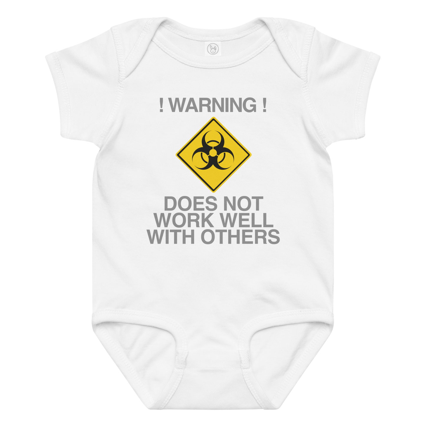 "!Warning! Does Not Work Well With Others" printed on a white baby jersey bodysuit laying on a flat surface amongst other clothes