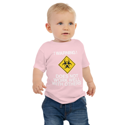 "!Warning! Does Not Work Well With Others" printed on a pink baby jersey short sleeve tee worn by a male
