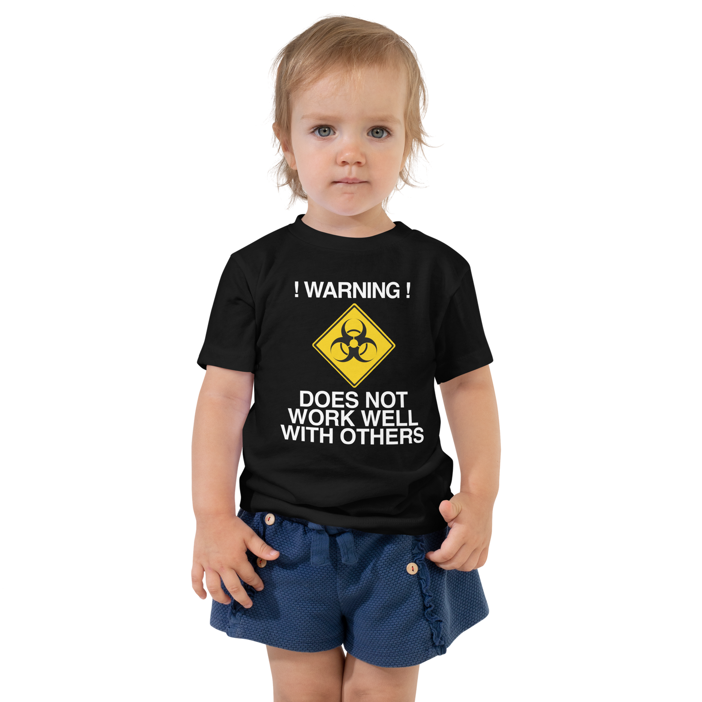 "!Warning! Does Not Work Well With Others" printed on a black toddler short sleeve tee worn by a female