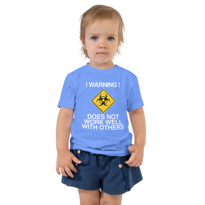 "!Warning! Does Not Work Well With Others" printed on a heather columbia blue toddler short sleeve tee worn by a female