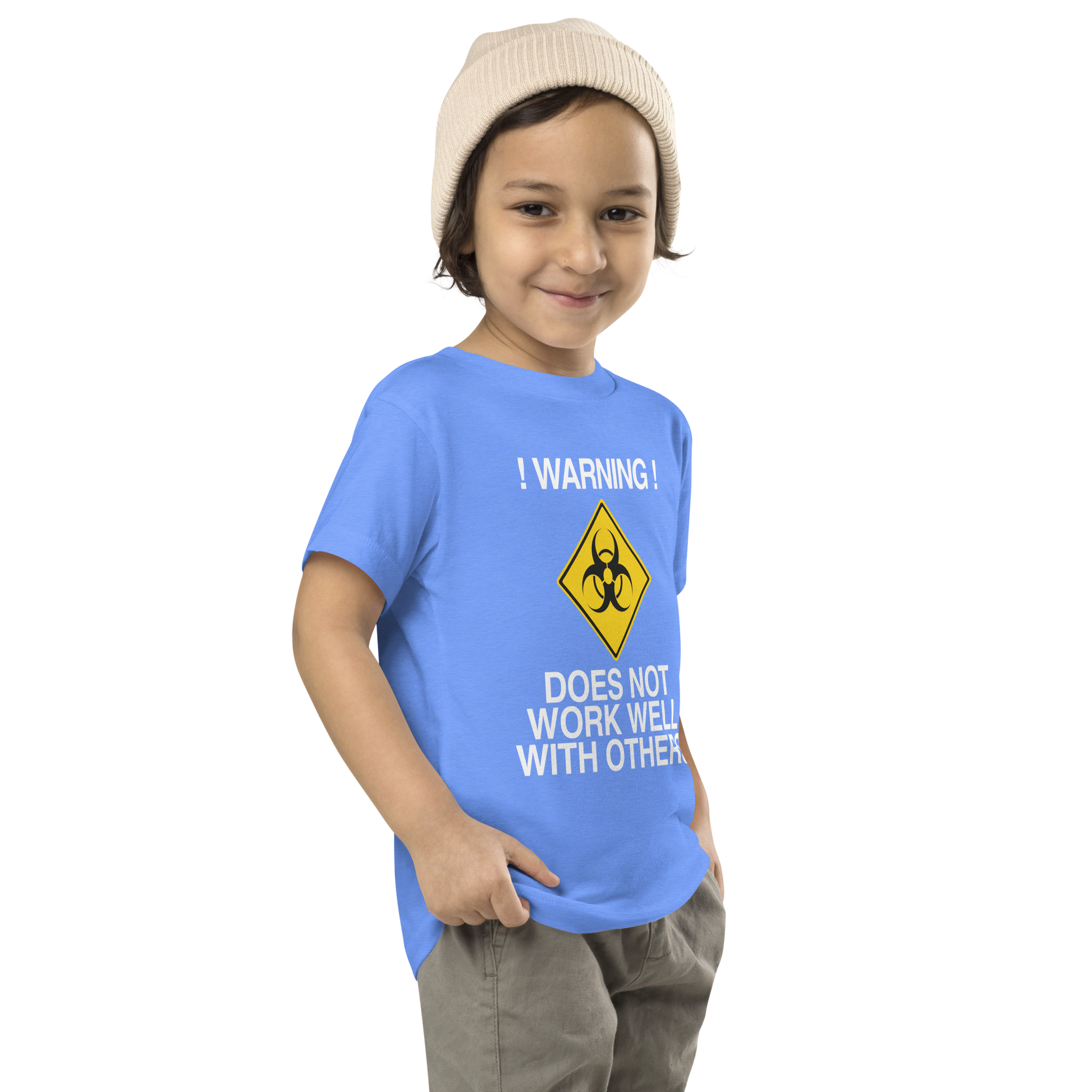"!Warning! Does Not Work Well With Others" printed on a heather columbia blue toddler short sleeve tee worn by a male who is also wearing a knit cap
