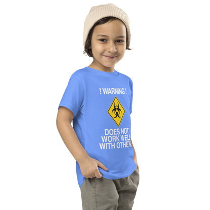 "!Warning! Does Not Work Well With Others" printed on a heather columbia blue toddler short sleeve tee worn by a male who is also wearing a knit cap
