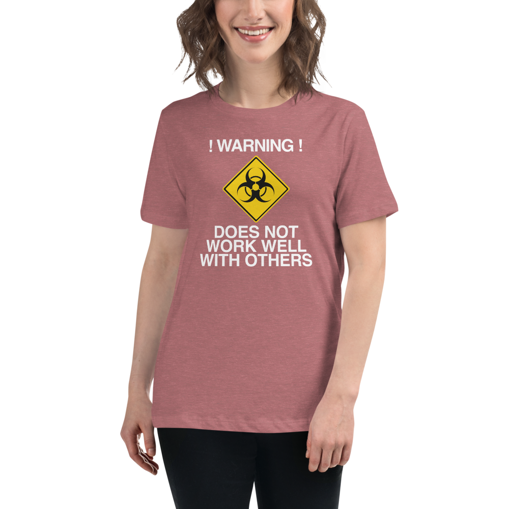 "!Warning! Does Not Work Well With Others" printed on a heather mauve women's relaxed t-shirt worn by a female