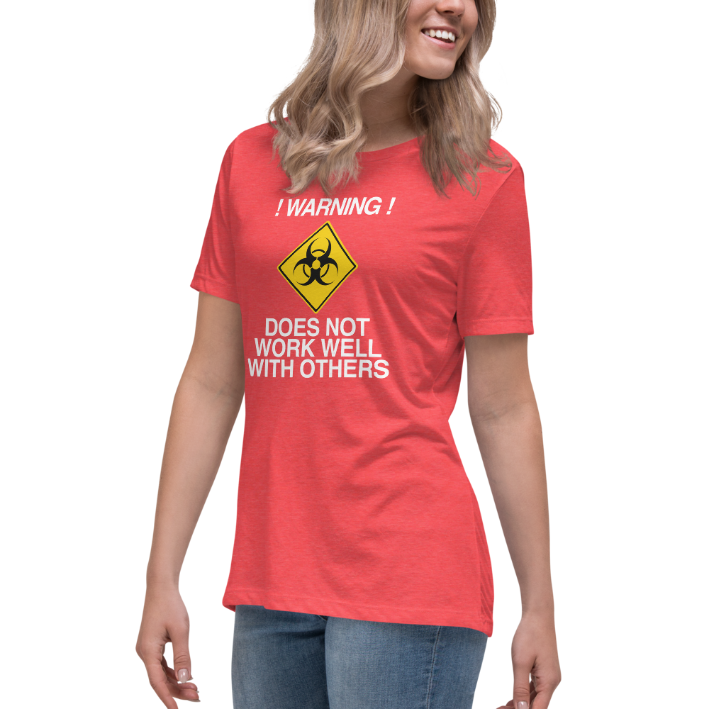 "!Warning! Does Not Work Well With Others" printed on a heather red women's relaxed t-shirt worn by a female