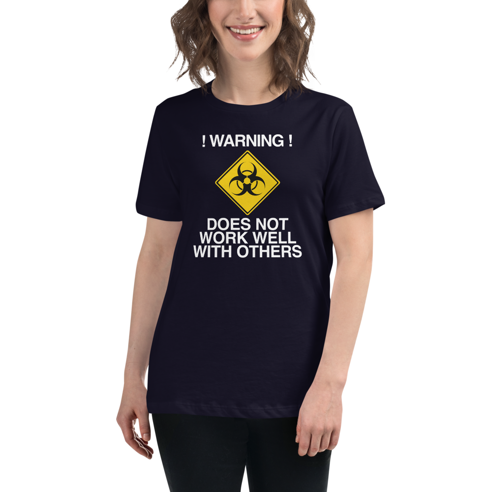 "!Warning! Does Not Work Well With Others" printed on a navy women's relaxed t-shirt worn by a female