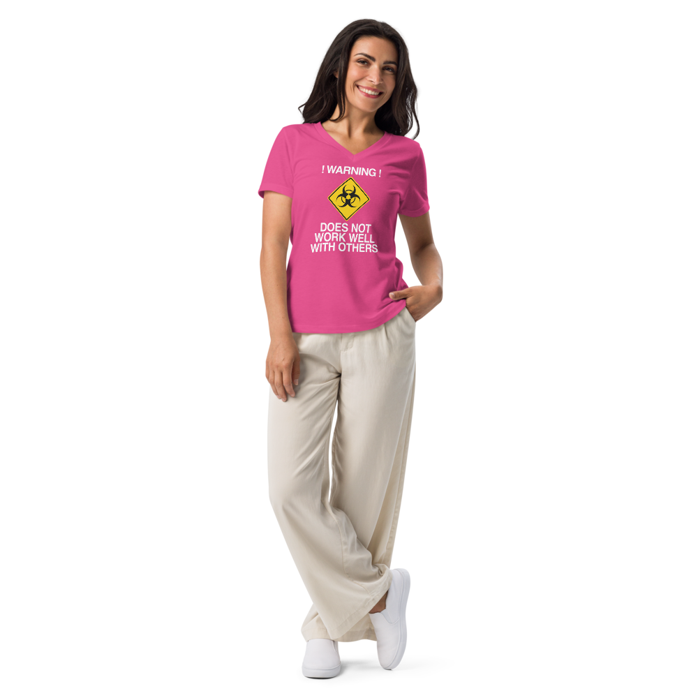 "!Warning! Does Not Work Well With Others" printed on a berry women's relaxed v-neck t-shirt worn by a female