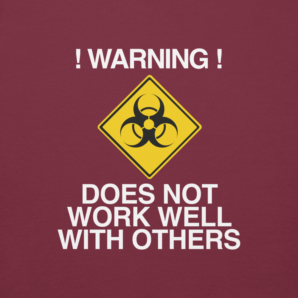 "!Warning! Does Not Work Well With Others" printed on a maroon background