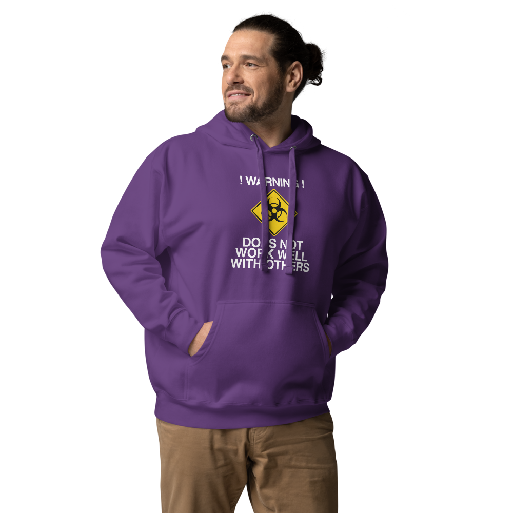 "!Warning! Does Not Work Well With Others" printed on a purple unisex hoodie worn by a male