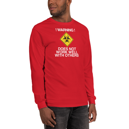 "!Warning! Does Not Work Well With Others" printed on a red men's long sleeve shirt worn by a male