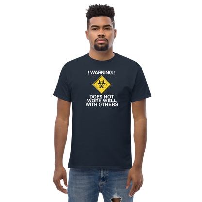 "!Warning! Does Not Work Well With Others" printed on a navy unisex classic tee worn by a male