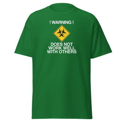 "!Warning! Does Not Work Well With Others" printed on a turf green on an invisible body