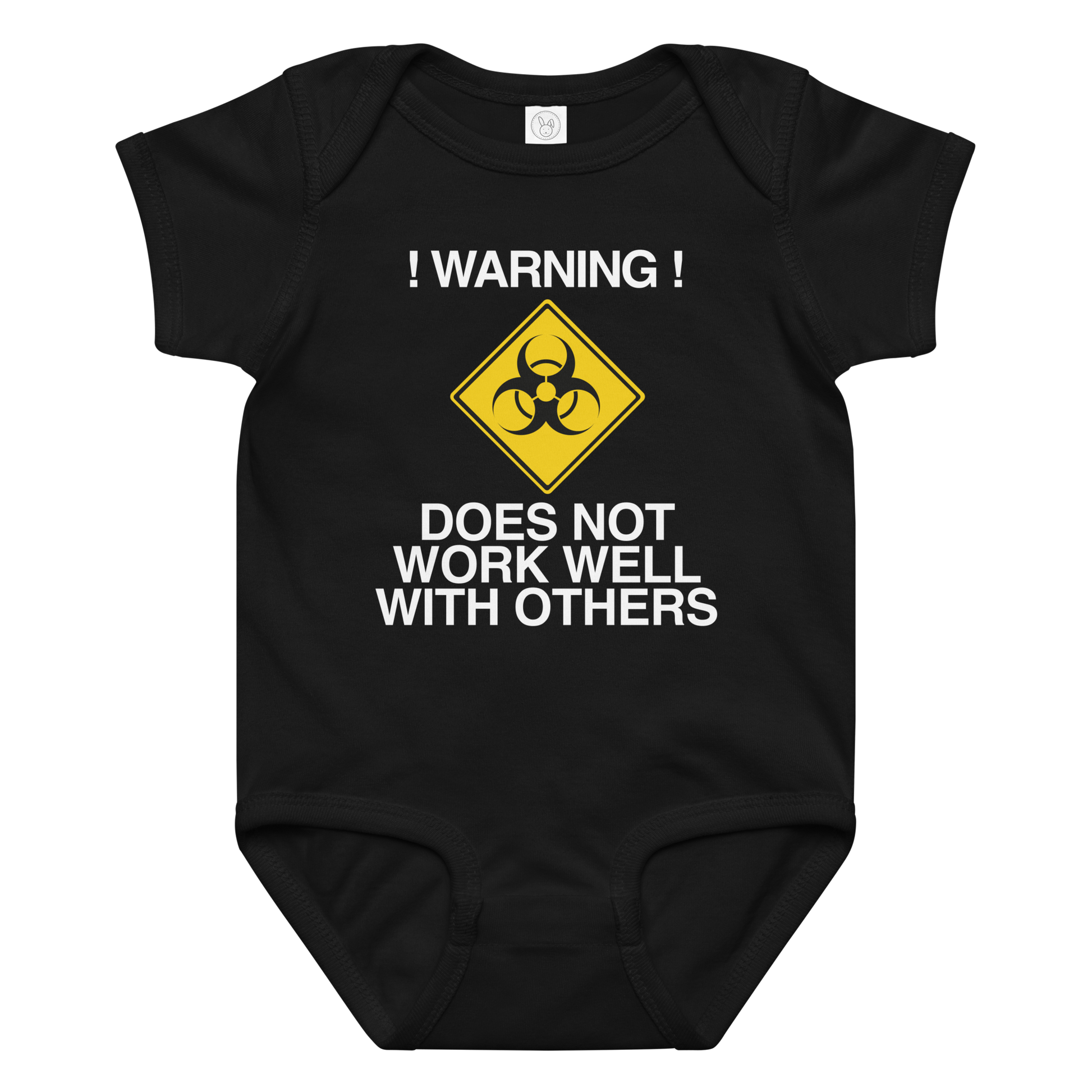 "!Warning! Does Not Work Well With Others" printed on a black baby jersey bodysuit laying on a flat surface amongst other clothes