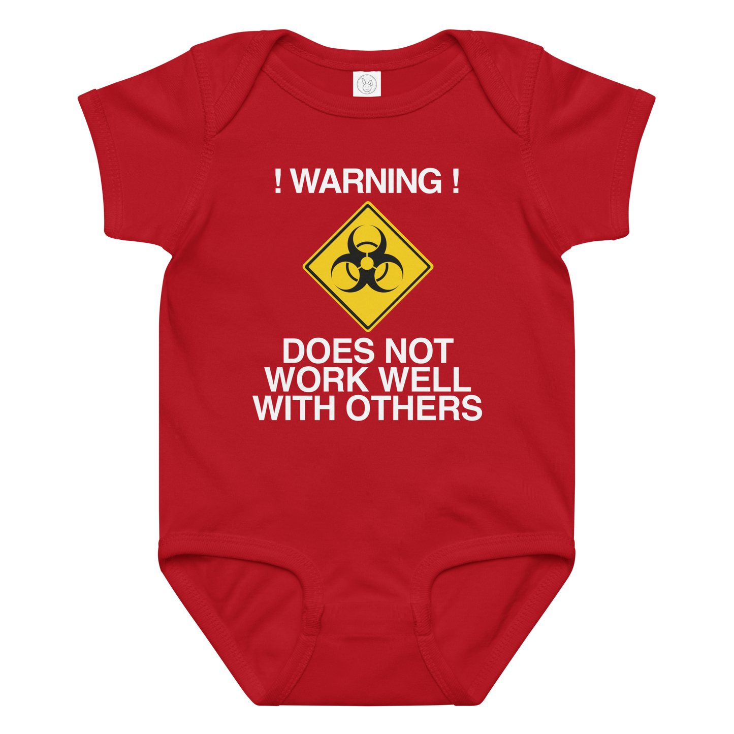 "!Warning! Does Not Work Well With Others" printed on a red baby jersey bodysuit laying on a flat surface amongst other clothes