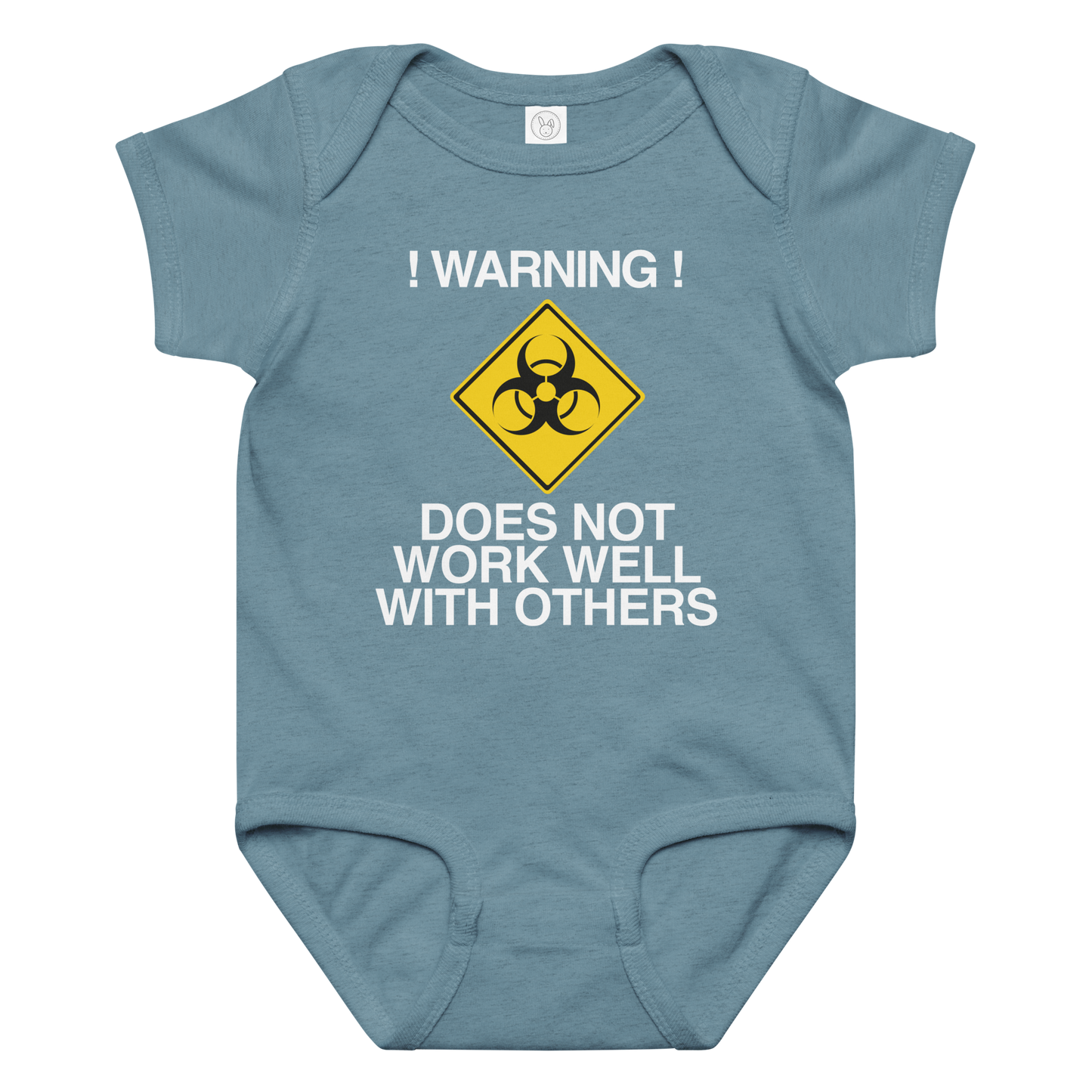 "!Warning! Does Not Work Well With Others" printed on a vintage indigo baby jersey bodysuit laying on a flat surface amongst other clothes