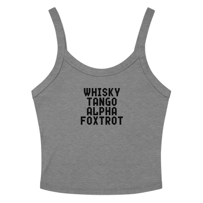 "Whisky Tango Alpha Foxtrot" printed on a athletic heather women's micro-rib tanktop laying on a flat surface amongst sunglasses and shorts