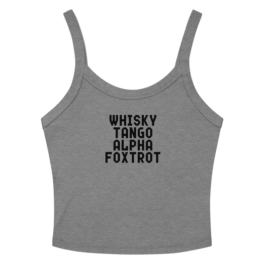 "Whisky Tango Alpha Foxtrot" printed on a athletic heather women's micro-rib tanktop laying on a flat surface amongst sunglasses and shorts
