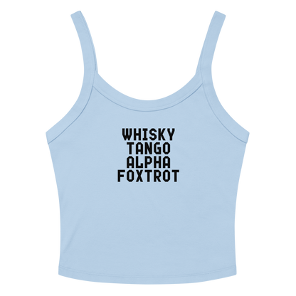 "Whisky Tango Alpha Foxtrot" printed on a solid baby blue blend women's micro-rib tanktop laying on a flat surface amongst sunglasses and shorts
