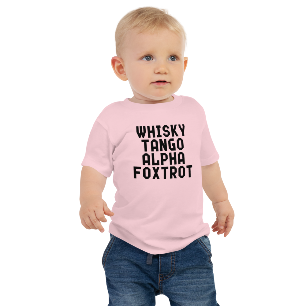 "Whisky Tango Alpha Foxtrot" printed on a pink baby jersey short sleeve tee worn by a male