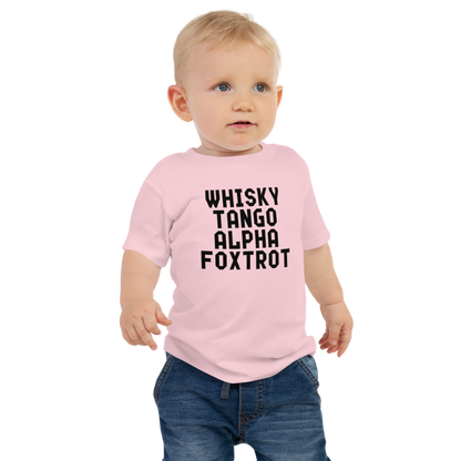 "Whisky Tango Alpha Foxtrot" printed on a pink baby jersey short sleeve tee worn by a male