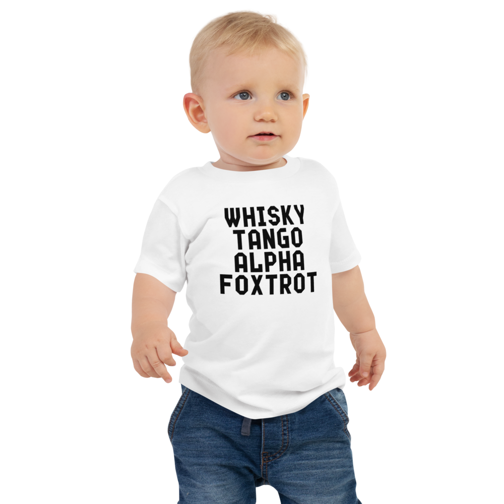 "Whisky Tango Alpha Foxtrot" printed on a white baby jersey short sleeve tee worn by a male